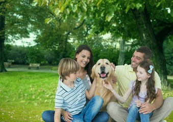 Happy family with pet dog enjoying in park