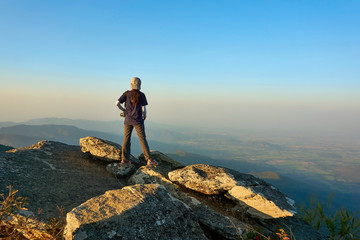 Obraz premium Young traveler is standing at the mountain view point.