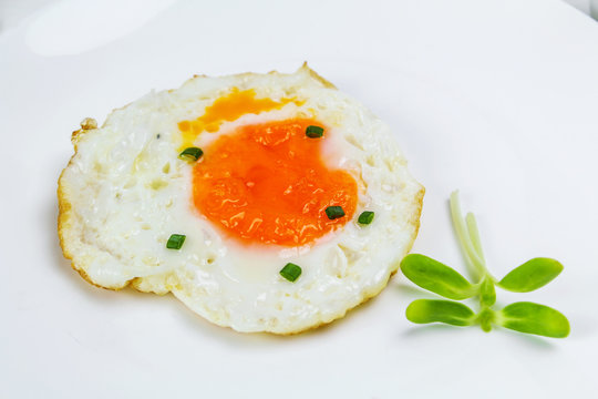 fried egg heart-shaped for breakfast on plate
