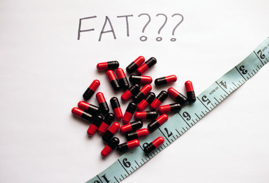 Weight Loss Concept With Fat Burner Pills And Measuring Tape