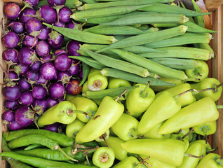 vegetables in cobs in a rustic wooden crate, Bell pepper, eggplant and roselle