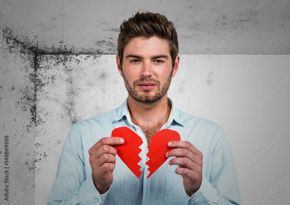 Wall mural Upset man standing with a broken heart