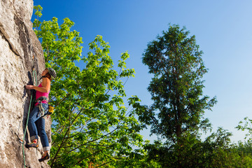 Fototapeta premium Woman rock climbing on Ontario's Niagara Escarpment in Canada