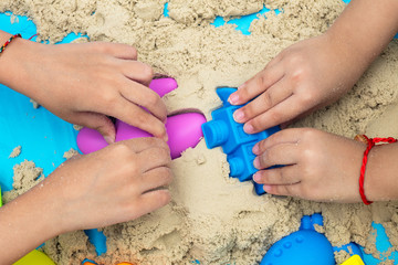 Childs hand close up playing kinetic sand