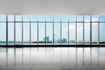 empty floor and cityscape of modern city from window