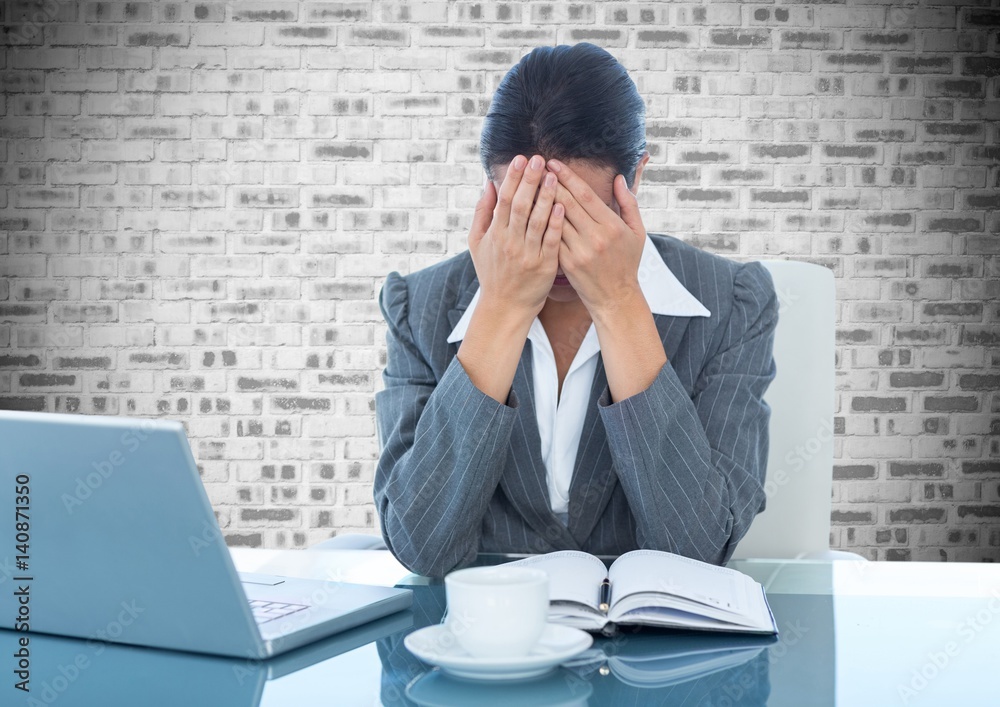 Poster Depressed businesswoman sitting at desk with laptop and diary