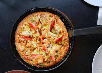 DeliciousSeafood Pizza in tray on table