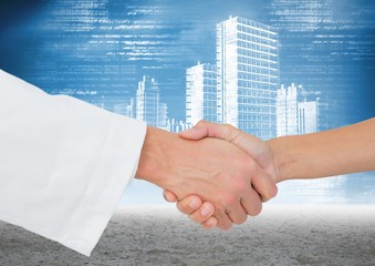 Doctor and patient shaking hands against cityscape in background