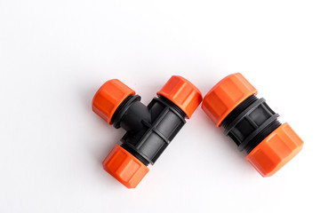 Orange garden water hose nozzle and connectors isolated on white background with soft shadow. Photo with clipping path
