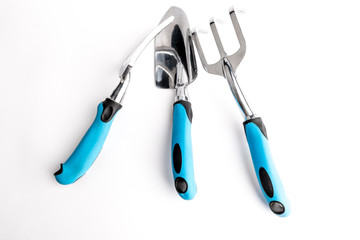 Small garden tool. Shovel, rake and fork on a white background