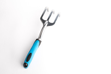 Small garden tool. Rake, used to loosen the soil