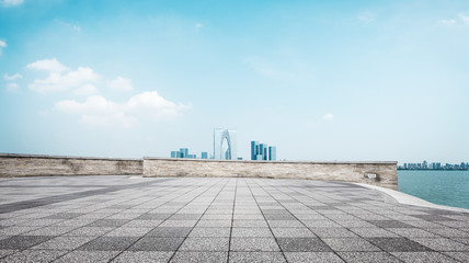 empty brick floor and cityscape of modern city