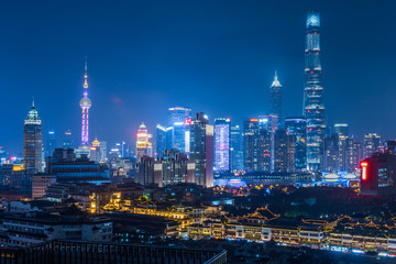 Fototapeta na wymiar illuminated cityscape at night in financial district of China.