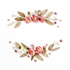 Round frame wreath with roses, pink flower buds, branches and dried leaves isolated on white background. Flat lay, top view. Flower mockup background