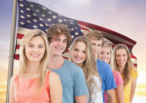 Happy friends standing in a row against  american flag