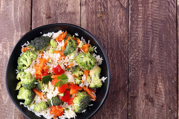 Colorful rice and vegetable salad - fresh mixed colorful healthy vegetarian food