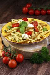 Traditional Italian penne pasta, fresh mozzarella, fresh tomato