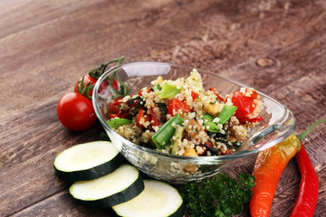 Delicious vegetarian quinoa salad with bell pepper, cucumber and tomatoes