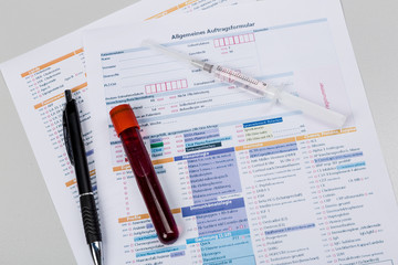 Analyseformular mit Spritze und Blutprobe
