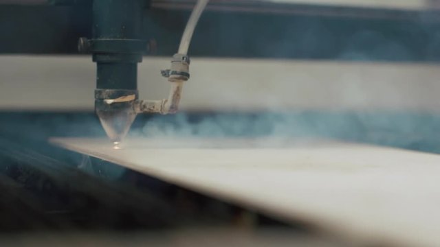 Laser cutting on wood. Slow motion.