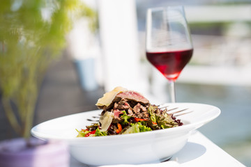 beef salad serve by the river with red wine