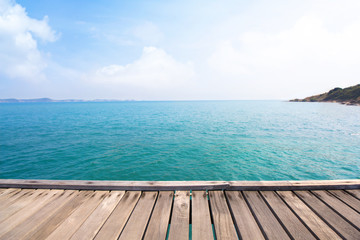Fototapeta premium Wooden bridge over blue sea and tropical island beach background.