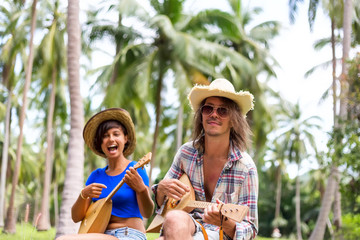 Happy people playing music at palm trees background