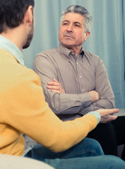 Adult father and son solve problems