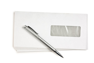 stack of mail envelopes and a pen