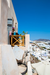 View of Fira town - Santorini island,Crete,Greece. White concrete staircases leading down to beautiful bay with clear blue sky and sea