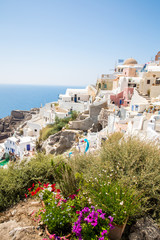 View of Fira town - Santorini island,Crete,Greece. White concrete staircases leading down to beautiful bay with clear blue sky and sea