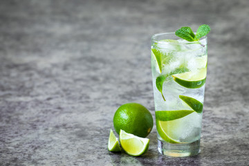 Homemade lemonade with ice lime and mint in a glass beaker