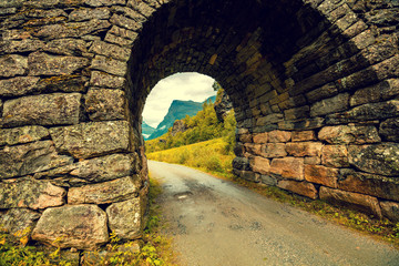 Stone arch over the road. Beautiful nature