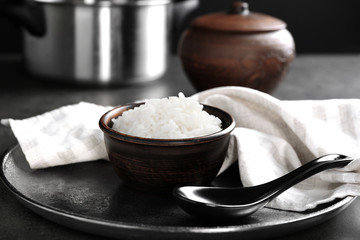 White rice in bowl with spoon, closeup