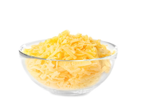 Glass bowl with grated cheese on white background