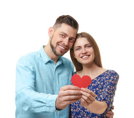 Happy young couple with red heart on white background