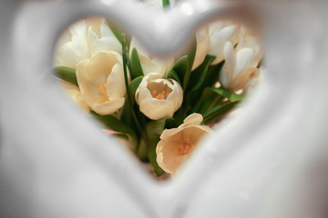 View on wedding bouquet through porcelain heart
