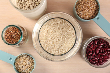 Kitchen containers with groceries on wooden table
