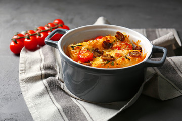 Delicious stuffed cannelloni in ceramic pot on table