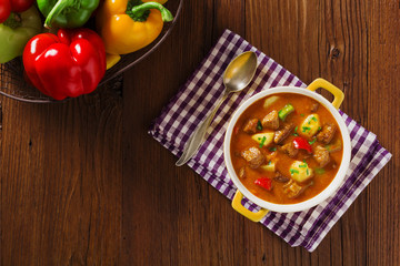 Beef stew served with cooked potatoes.