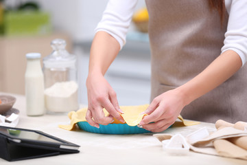 Obraz na płótnie Canvas Young woman preparing tasty pie in kitchen