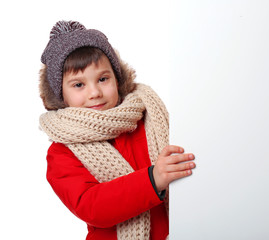 Cute little boy in warm clothes with poster on white background