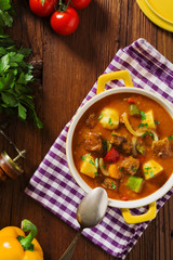 Beef stew served with cooked potatoes.