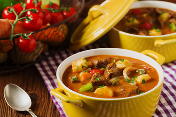 Beef stew served with cooked potatoes.