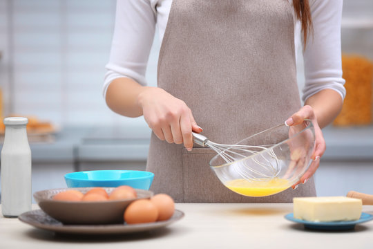 Young woman cooking in kitchen