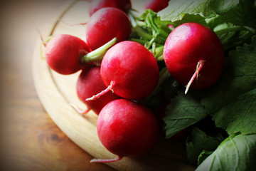 fresh radishes on cutting board