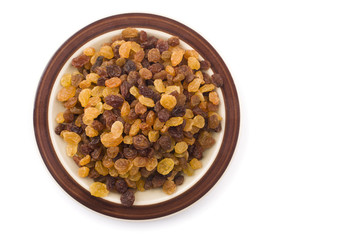 Raisins on bowl over white bakcground