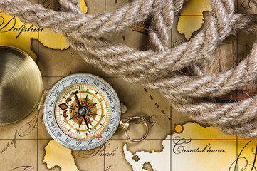 Fototapeta na wymiar compass and rope on map