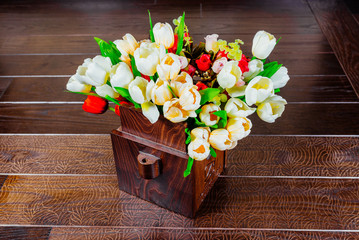 Spring flowers in a wooden flowerpot