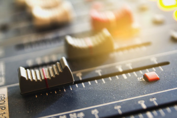 Closeup audio mixer slider in the control room.